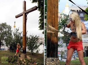 Topless Pussy Riot supporter taking down cross in Kiev